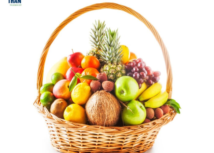 Placing the larger and heavier fruits at the bottom of the basket to create a stable foundation