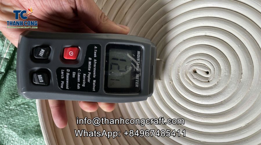 Moisture meter being used to test bamboo basket humidity level before shipment