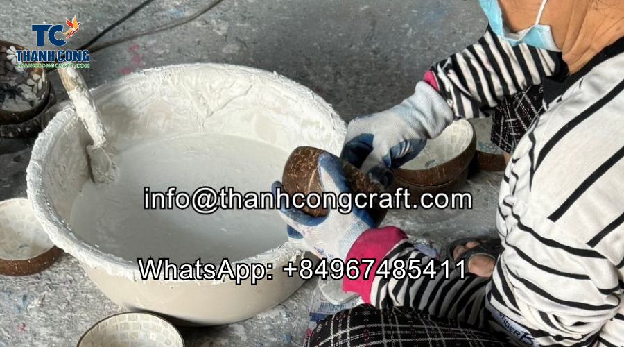 The worker is sanding the surface and applying paint.