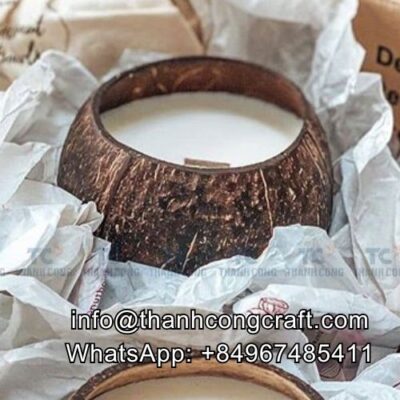Handmade coconut shell candle with white wax and natural brown shell