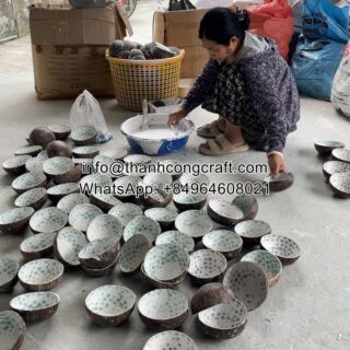Vietnamese artisan painting coconut bowls for bulk wholesale orders